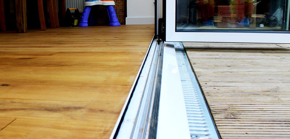 internal level threshold for a bi-fold door with a white cill with a gully drain to the front