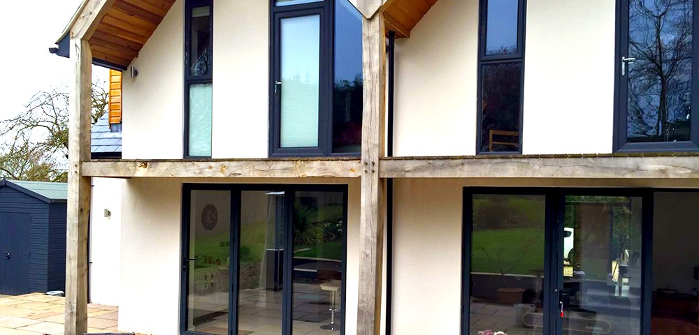 three sets of grey bi-fold doors with matching windows in nottingham