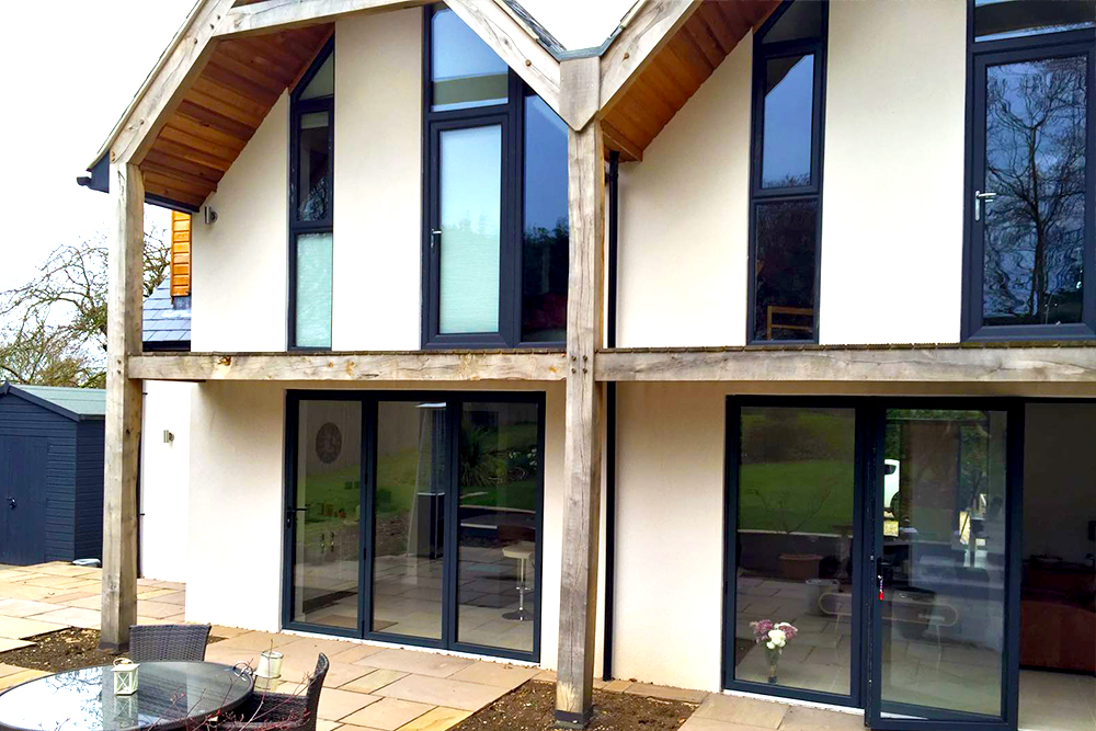 three sets of grey bi-fold doors with matching windows in nottingham