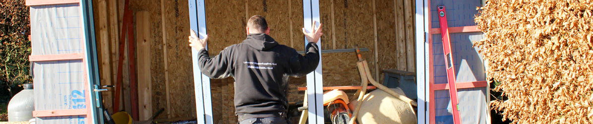 Man installing a bi-fold door into a pool room