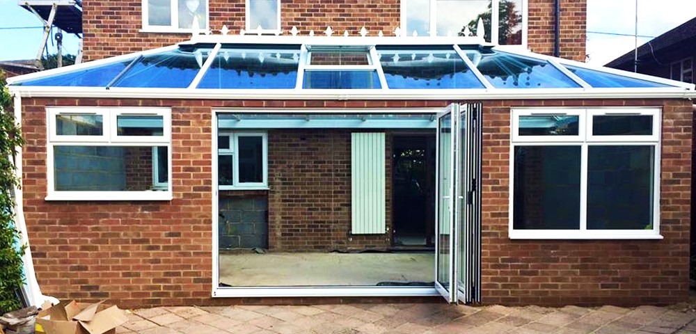 bi-fold door and roof lantern installed into an unfinished extention