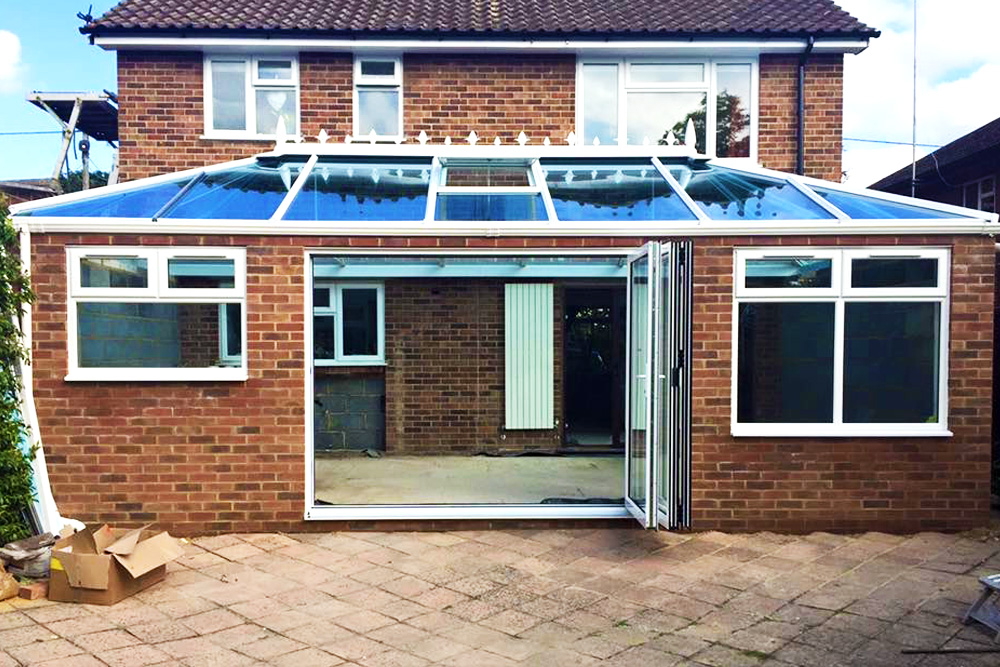 bi-fold door and roof lantern installed into an unfinished extention